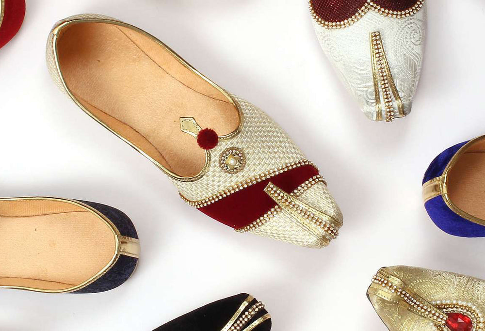 Wedding SHerwani Jutti Mojari with gold, red, and blue accents on a white background